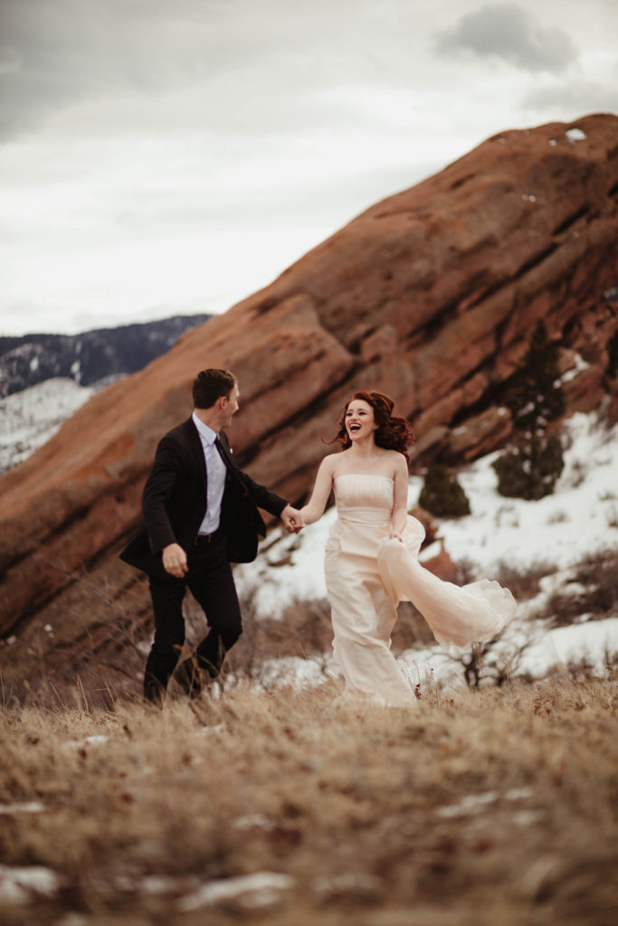 Wedding Professional Photographer in Denver, Colorado. Beautiful bride and groom in a professional photo session ,beautiful bride and groom holding hands and walking with a mountain view