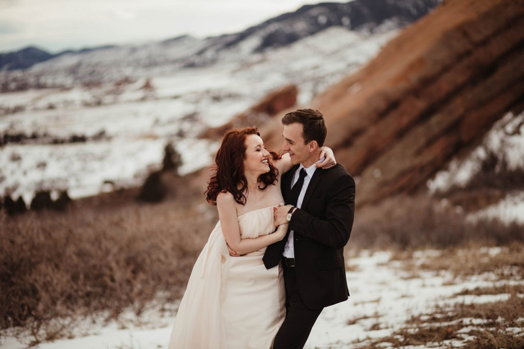 Wedding Professional Photographer in Denver, Colorado. Beautiful bride and groom in a professional photo session ,beautiful bride and groom hugging and kissing with a Colorado mountain view