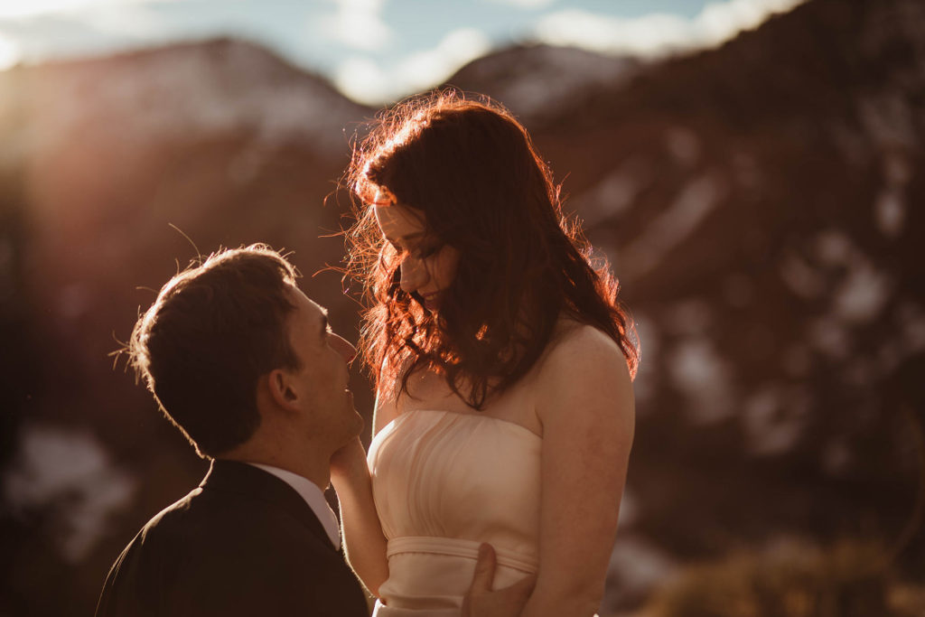 Wedding Professional Photographer in Denver, Colorado. Beautiful bride and groom in a professional photo session , Mountain view handsome groom with a beautiful bride on the sunset light