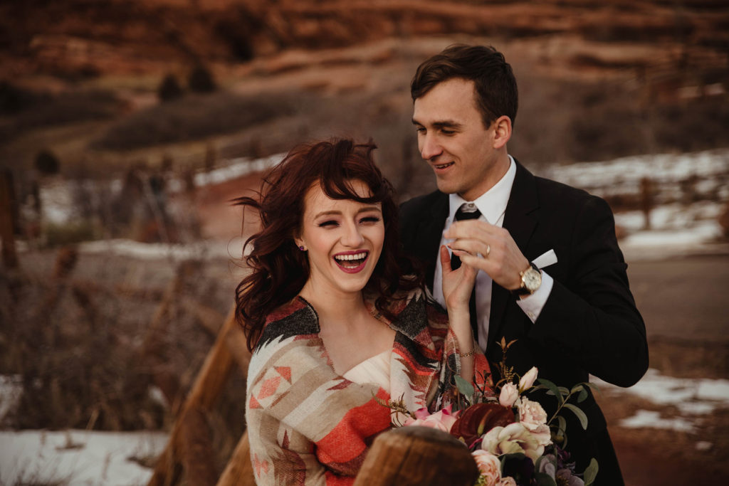 Wedding Professional Photographer in Denver, Colorado. Beautiful bride and groom in a professional photo session , Mountain view , laughing with each other and holding a bride bouquet